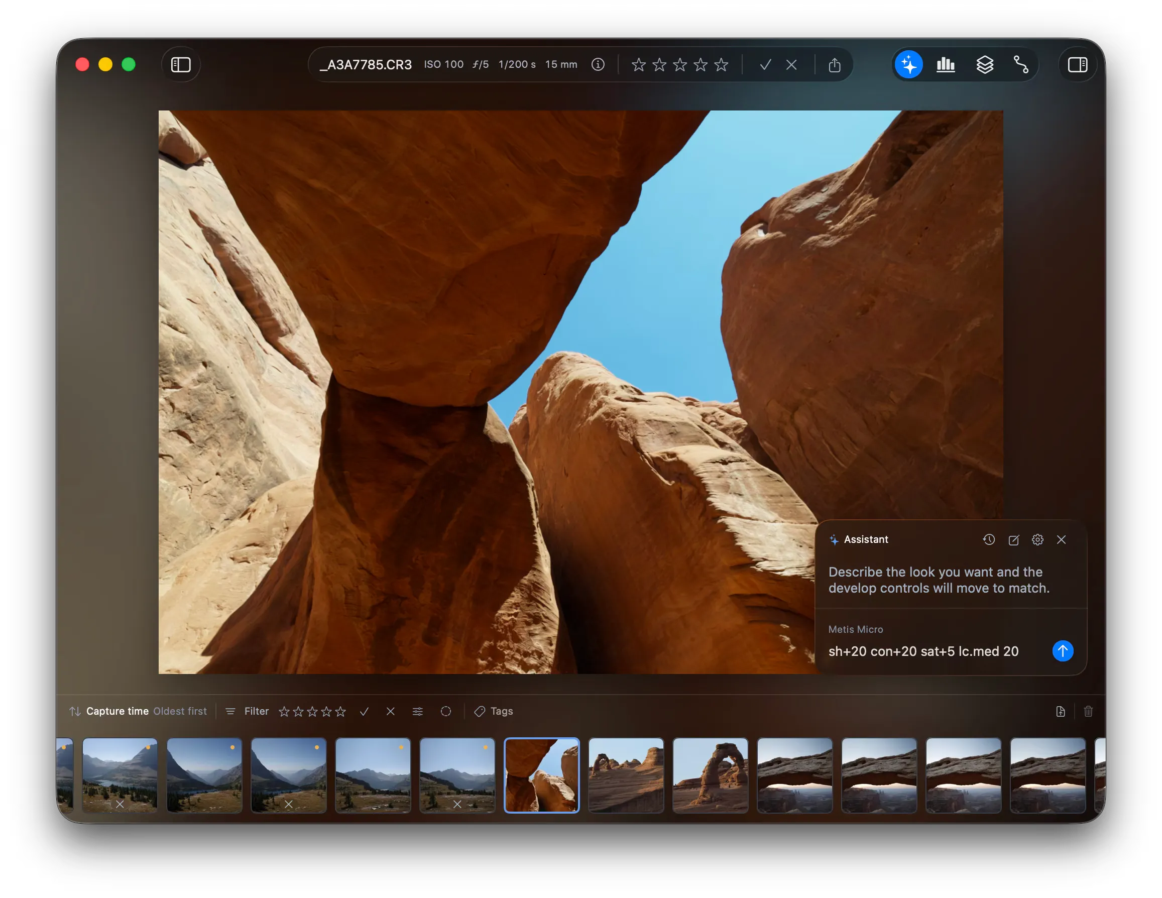 The assistant pane over a photo of a rock arch. The pane reads “Describe the look you want and the develop controls will move to match.” The composer holds the text “sh+20 con+20 sat+5 lc.med 20”.