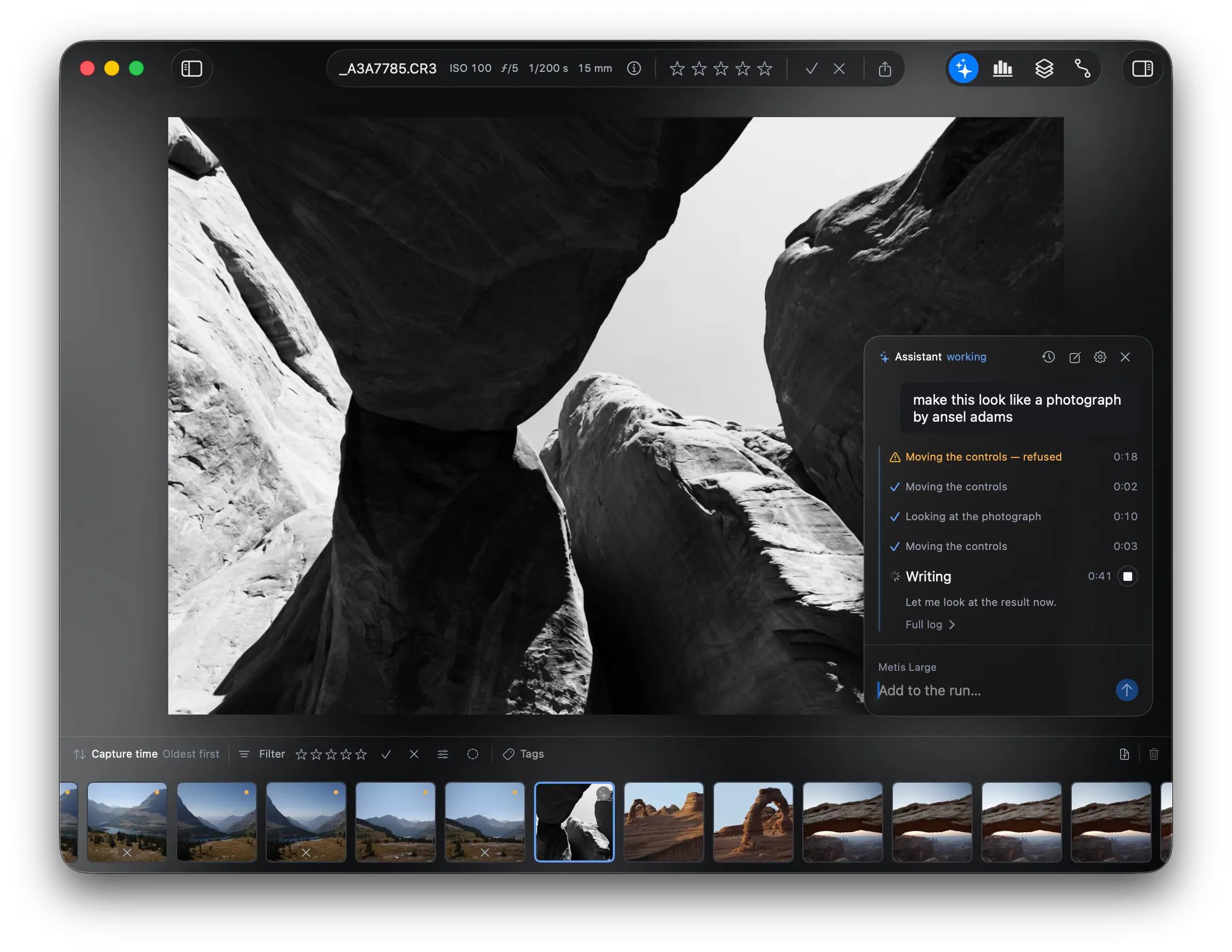 The assistant pane on a black and white photo. The request reads “make this look like a photograph by ansel adams”. The step list shows four finished steps and a fifth step, Writing, still at work. The model is Metis Large.